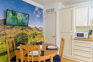 uma sala de jantar com uma mesa com um quadro na parede em Spectacular 3 Bed in Blackheath em Londres