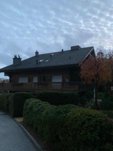 a house with a porch and a roof at Garden Studio Apartment Crans Montana in Crans-Montana