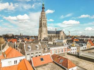 a view of a city with a clock tower at TheBridge29 boutique apartment in Breda