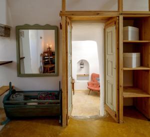 a room with a mirror and an open door at Sail Away House in Emporio in Emporio Santorini +10 photos