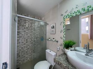 a bathroom with a toilet and a sink and a shower at Apartamento BEIRA MAR in Fortaleza