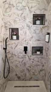 a bathroom with a shower with three pictures on the wall at Boutique D'amici Ostia in Lido di Ostia +49 photos