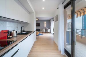 a kitchen with a view of a living room at Monte Carlo Monaco Border, Swimming Pool, Parking, See View, Terrace in Beausoleil