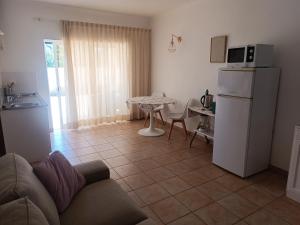 a living room with a couch and a table and a refrigerator at Costamar in Lagos