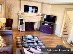 uma sala de estar com lareira e televisão em The House Hotels - Thoreau 2 em Lakewood