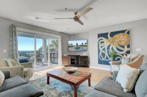 a living room with a couch and a table at Ocean Blvd 102 Beautiful Condo with Ocean Views in Isle of Palms