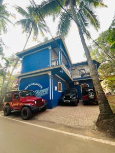 a blue building with cars parked in front of it at Casa De Calangute Beach in Calangute