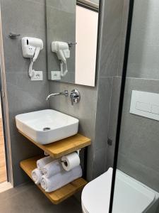 a bathroom with a sink and a toilet at EMAAR Hotel Ksamil - BEACHFRONT , Newly Renovated in Ksamil