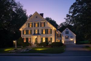 a white house with lights on the front of it at Camden Maine Stay Inn in Camden