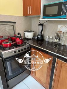 a kitchen with a stove with a sign that reads the carleton house at The Captain House in Pucallpa