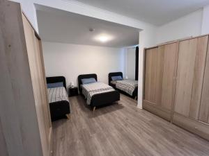 a small room with two beds and a closet at Gera Apartment EG in Gera