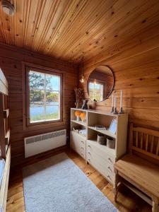 a room with a wooden cabin with a mirror at Villa Aiku in Leppäjärvi
