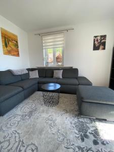 a living room with a couch and a table at Ferienwohnung Lara in Tiefgraben