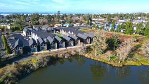 an aerial view of a house by the water at The Commons - Urban Coastal Lodging in Seaside
