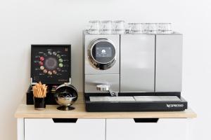 a counter with a coffee machine on a table at La Lys Rooms & Suites in Ghent