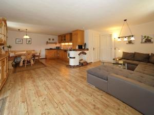 a living room with a couch and a table and a kitchen at Waldhaus Sonnenberg Apartment 2 in Drachselsried