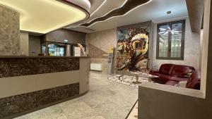 a lobby with a leather chair and a couch at Hotel Roma in Bologna