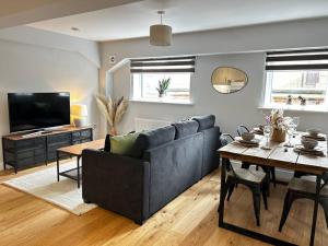 a living room with a couch and a table at Trendy City Centre Apartment with FREE Parking in Southampton