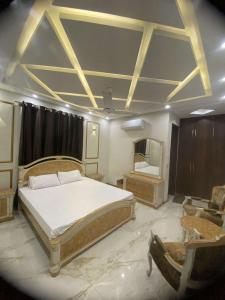 um quarto com uma cama grande e um espelho em InTown Guesthouse em Islamabad