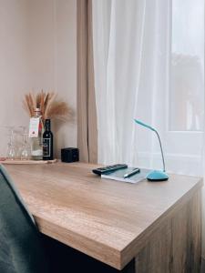 a wooden table with a remote control and a mouse at Dions Rooms in Norderney