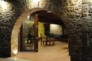 an archway in a stone wall with a door at Simosmare Resort in Elafonisos