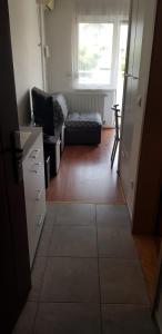 a living room with a couch and a television at Apartman Petar Banja Koviljača in Banja Koviljača