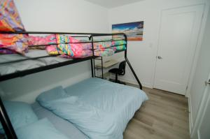 a bedroom with two bunk beds and a pillow at Niagara Escape Crib: 3km from NiagaraFalls in Niagara Falls