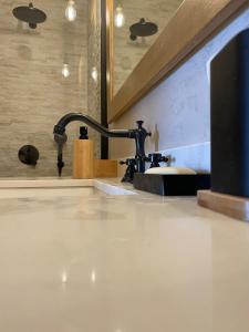 a bathroom with a sink and a faucet at Delphi Gorge-view Chalet, Arachova in Arachova