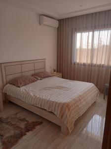 a bedroom with a large bed with a window at VIP Tunisia in La Goulette