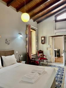 a bedroom with a bed and a living room at Erietta Suites in Chania