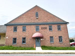 a red brick building with a door and the number zero at Kiteville Lancaster in Strasburg
