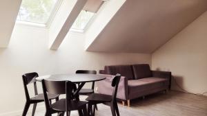 a room with a couch and a table and chairs at apartamenty nad jeziorem in Turawa