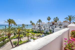 a view of the beach from the balcony of a resort at Hanami Alcazaba Beach Duplex Sea View in Estepona