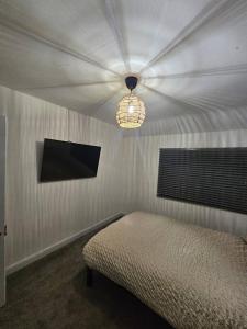 a bedroom with a bed and a ceiling with a light at Quiet family home in Tettenhall