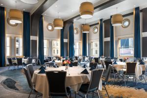 a conference room with tables and chairs and windows at Courtyard Seattle Downtown / Pioneer Square in Seattle