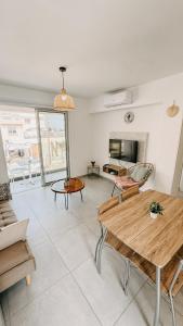 a living room with a table and a couch at WAKE UP BY THE SEA FLATS in Protaras