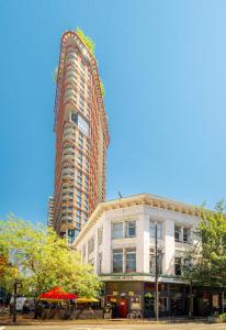 a tall building in the middle of a city at The Cambie Hostel Gastown in Vancouver