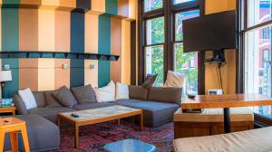 a living room with a couch and a table at The Cambie Hostel Gastown in Vancouver