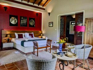 a bedroom with a bed and a table and chairs at Gal Oya Lake Club 