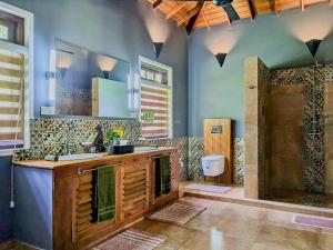 a bathroom with a shower and a sink and a toilet at Gal Oya Lake Club 