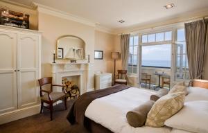 a bedroom with a large bed and a fireplace at The Marine in Whitstable
