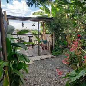 a patio with a table and chairs in a garden at Eco Camping Aventura Salento in Salento