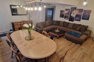 a living room with a table and a couch at Le Grand Bourgeois in Appoigny