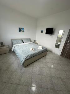 ein Schlafzimmer mit einem Bett und einem TV an der Wand in der Unterkunft Antonio's Home in Bari