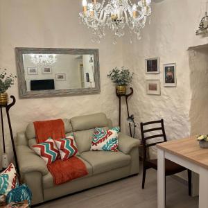 a living room with a couch and a mirror at Townhouse 7 in Dingli
