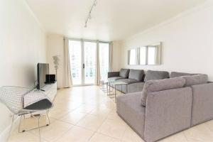 a living room with a couch and a tv at Komffy Home with King Bed & Ocean View at Tides in Hollywood