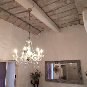 a chandelier hanging in a room with a mirror at Townhouse 7 in Dingli