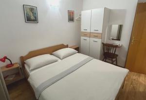 Postel nebo postele na pokoji v ubytování Apartman Krstičević