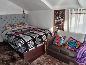 a bedroom with a bed and a couch at CHUYPAS DEL TITICACA in Puno