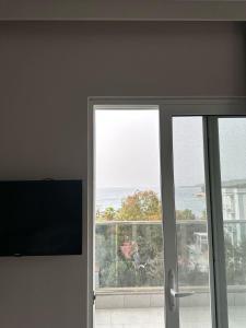 a sliding glass door with a view of the ocean at Summer Gate Hotel in Ksamil